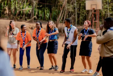 Young people of different nationalities dance and laugh.