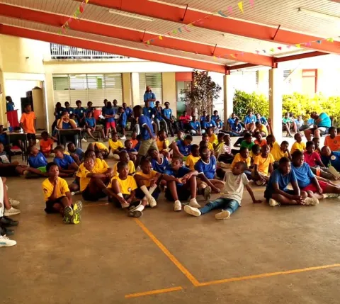 Scouts in a meeting, all siting with different color t-shirts