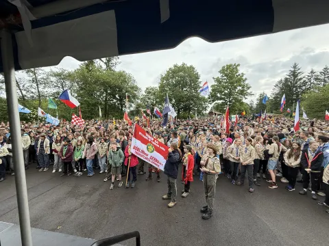 Scouts standing and holding flags during the opening ceremony.