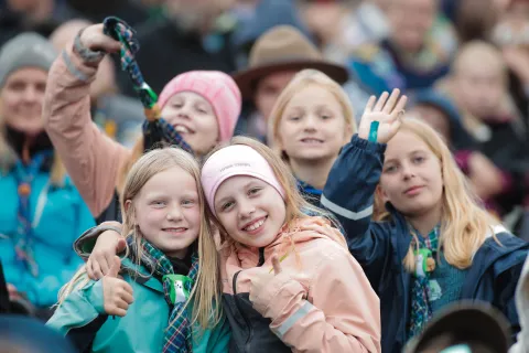 Five Scouts say hi and smile at the camera.