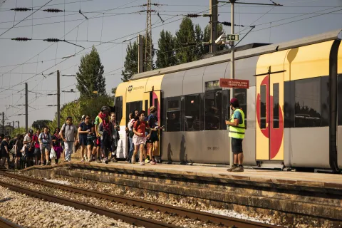 Scouts walk towards a train in Portugal.