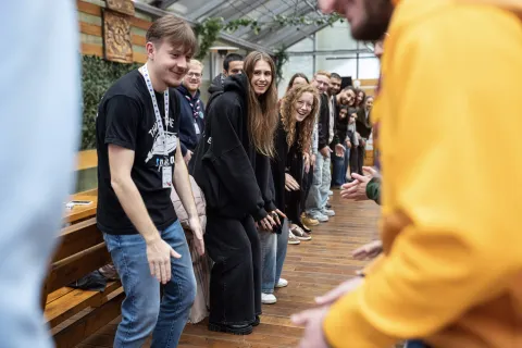 Young people stand in line making the same movements.