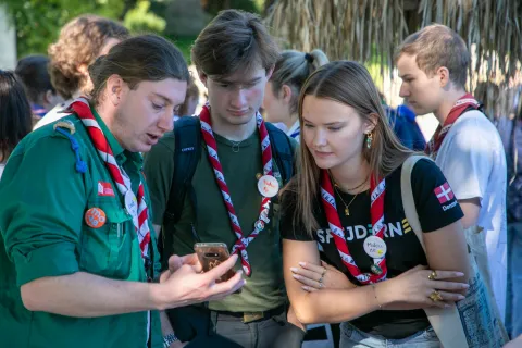 Participants from Denmark and Switzerland checking content on a phone.