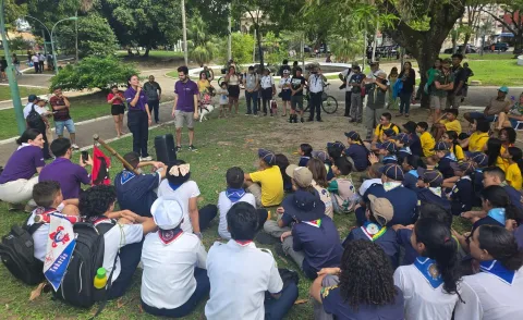 Scouts speak to a group at COP30