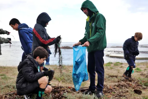 Scouts collect litter from a beach in Portugal.