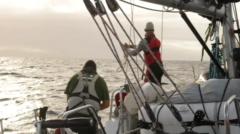 Two members of the crew work on the deck.