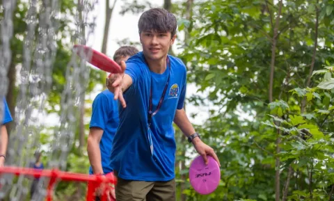 American Scout throws a frisbee