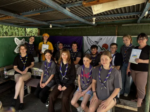 A group of Ukrainian Scouts looking at the camera, two of them hold the game mentioned in the article.