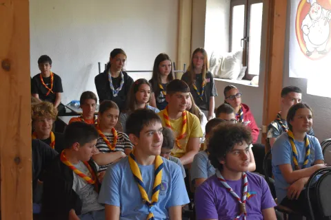 Teenagers of different ages sit in a room.
