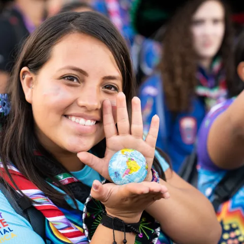 Mexican girl holding globe at world scout Jamboree