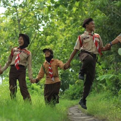 scouts running in the forest