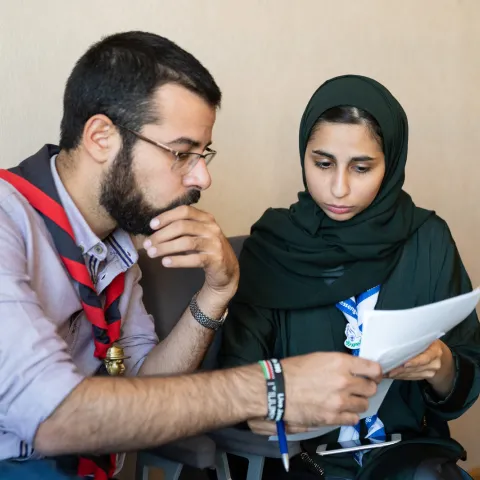 Two scouts reading a paper