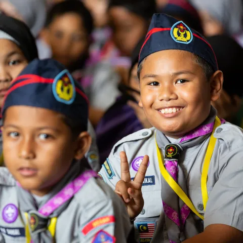 Malaysian Scout making the peace sign