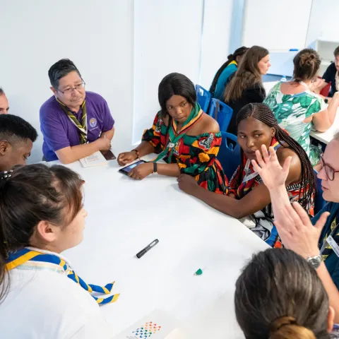 a group of volunteers having a discussion around a table