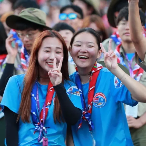 Smiling Scouts display peace sign