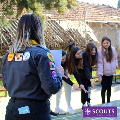 A Scout leader facilitates an activity.