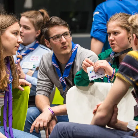 Four young Scouts talk.